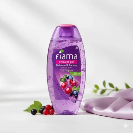 Purple bottle of Fiama Blackcurrant & Bearberry shower gel with image of berries, next to a purple cloth and fresh leaves.