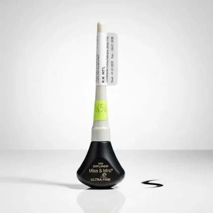 Miss & Mrs. Ultra Fine Dip Liner in a black teardrop-shaped bottle with a white cap and applicator. A small black eyeliner swatch is next to it on a white surface.