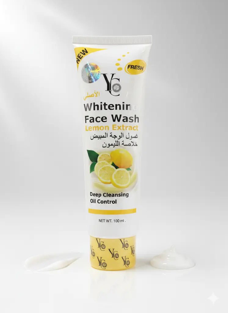 Studio shot of YC Whitening Face Wash Lemon Extract 100ml tube, showing the yellow and white packaging, and two blobs of the white face wash product on either side of the base.